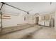 A two-car garage featuring a laundry area, shelving, and garage door at 8959 Sw 96Th Ln # A, Ocala, FL 34481