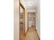 Hallway with wood grain flooring, white walls, and views of rooms on either side at 8959 Sw 96Th Ln # A, Ocala, FL 34481