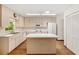 Kitchen featuring light wood cabinets, an island, wood floors and white appliances at 8959 Sw 96Th Ln # A, Ocala, FL 34481