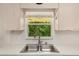Kitchen sink with stainless steel fixtures and a large window overlooking the backyard at 8959 Sw 96Th Ln # A, Ocala, FL 34481
