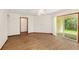 Living room featuring wood floors, a ceiling fan, and sliding glass doors to the covered patio at 8959 Sw 96Th Ln # A, Ocala, FL 34481
