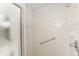 This shower features grab bars, a shower head, a soap dish, and tiled walls at 8959 Sw 96Th Ln # A, Ocala, FL 34481