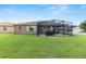 Spacious backyard featuring a large, screened lanai and a well-maintained lawn, ideal for relaxing and entertaining at 9222 Sw 97Th Cir, Ocala, FL 34481