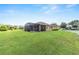 Spacious backyard featuring a large, screened lanai and a well-maintained lawn, perfect for outdoor entertaining at 9222 Sw 97Th Cir, Ocala, FL 34481