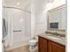 Bathroom features a shower-tub combo, granite countertop vanity, and modern fixtures at 9222 Sw 97Th Cir, Ocala, FL 34481