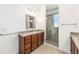Bathroom featuring granite sink, updated vanity, and tiled walk-in shower at 9222 Sw 97Th Cir, Ocala, FL 34481