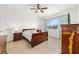 Bright bedroom features tiled floors, large window, and modern furnishings at 9222 Sw 97Th Cir, Ocala, FL 34481