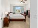 A cozy bedroom with a ceiling fan, nice window, and neutral decor for a restful atmosphere at 9222 Sw 97Th Cir, Ocala, FL 34481