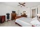 Comfortable bedroom features tiled floors, ceiling fan, and a well-lit dressing area at 9222 Sw 97Th Cir, Ocala, FL 34481
