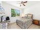 Cozy bedroom with a plush bed, complemented by a window view and a wooden nightstand at 9222 Sw 97Th Cir, Ocala, FL 34481