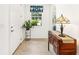 Bright foyer with tiled floor, decorative window treatment, and a charming console table at 9222 Sw 97Th Cir, Ocala, FL 34481