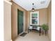 Inviting front porch features a stylish bench, decorative pillows, and a potted plant, creating a welcoming entrance at 9222 Sw 97Th Cir, Ocala, FL 34481