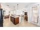 View of the open-concept kitchen featuring granite counters, a center island, and stainless steel appliances at 9222 Sw 97Th Cir, Ocala, FL 34481
