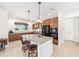Spacious kitchen features granite counters, center island, tile floors, and stainless steel appliances at 9222 Sw 97Th Cir, Ocala, FL 34481