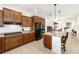Spacious kitchen features granite counters, center island, tile floors, and stainless steel appliances at 9222 Sw 97Th Cir, Ocala, FL 34481