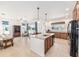 Open kitchen with island, granite countertops, and seamless transition to the living area, ideal for entertaining at 9222 Sw 97Th Cir, Ocala, FL 34481