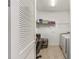 Laundry room featuring tile floors, ample storage and adjacent office space at 9222 Sw 97Th Cir, Ocala, FL 34481