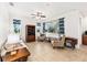Bright living room featuring a ceiling fan, neutral furnishings, large windows, and tile flooring at 9222 Sw 97Th Cir, Ocala, FL 34481