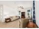 Open-concept living room with a ceiling fan, neutral furnishings, and large windows allowing natural light at 9222 Sw 97Th Cir, Ocala, FL 34481