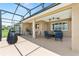 Spacious screened-in patio with a seating area and outdoor grill perfect for entertaining and relaxation at 9222 Sw 97Th Cir, Ocala, FL 34481