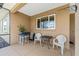 Inviting patio featuring neutral tones, a window and an outdoor seating area perfect for relaxation at 9222 Sw 97Th Cir, Ocala, FL 34481