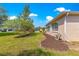 Well-maintained backyard with lush green grass, mature trees, and a glimpse of neighboring homes at 9746 Sw 89Th Loop, Ocala, FL 34481