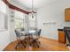 Dining area boasts a round table, chandelier lighting and a large window at 9746 Sw 89Th Loop, Ocala, FL 34481