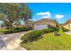 Charming single-story home featuring a two-car garage, well-maintained landscaping, and a light beige stucco exterior at 9746 Sw 89Th Loop, Ocala, FL 34481