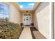 Welcoming front entrance with a decorative door, sidelights, and a well-maintained walkway with attractive shrubbery at 9746 Sw 89Th Loop, Ocala, FL 34481