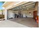 Spacious garage with overhead door, storage shelves, and ample room for parking and projects at 9746 Sw 89Th Loop, Ocala, FL 34481