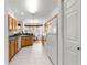 Bright kitchen with wooden cabinets, modern appliances, and an adjacent dining area at 9746 Sw 89Th Loop, Ocala, FL 34481