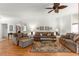 Living room featuring hardwood flooring, ceiling fan, and comfortable seating at 9746 Sw 89Th Loop, Ocala, FL 34481