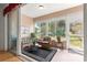 Inviting sunroom with wicker furniture, neutral walls, and large windows offering a view of the outdoors at 9746 Sw 89Th Loop, Ocala, FL 34481