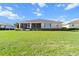 Well-maintained backyard with lush lawn, trimmed hedges, and a screened-in porch, ideal for relaxation and entertainment at 9926 Sw 95Th Loop, Ocala, FL 34481