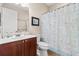 Bathroom featuring a single sink, a decorative mirror and a toilet with a beach-themed shower curtain at 9926 Sw 95Th Loop, Ocala, FL 34481