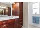 Bathroom featuring a sink, a decorative mirror and a glass-enclosed shower at 9926 Sw 95Th Loop, Ocala, FL 34481