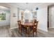 Dining room featuring a wood table, seating for five, and decorative window treatments at 9926 Sw 95Th Loop, Ocala, FL 34481