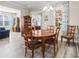Open concept dining room with views into the living room and foyer; wood table at 9926 Sw 95Th Loop, Ocala, FL 34481