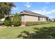 Beautiful home exterior showcasing well-manicured landscaping, lush green lawn, and a charming facade at 9926 Sw 95Th Loop, Ocala, FL 34481