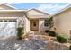 Welcoming front entrance with a brick walkway, beautiful landscaping, and a charming covered porch at 9926 Sw 95Th Loop, Ocala, FL 34481