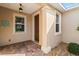 Charming front porch featuring brick flooring, decorative accents, and inviting curb appeal at 9926 Sw 95Th Loop, Ocala, FL 34481