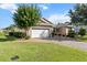 Attractive single-story home featuring a brick driveway, lush lawn, and well-maintained landscaping at 9926 Sw 95Th Loop, Ocala, FL 34481