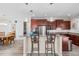 Open kitchen with cherry cabinets, stainless appliances, granite counters, and seating at the breakfast bar at 9926 Sw 95Th Loop, Ocala, FL 34481
