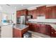 Gourmet kitchen features stainless steel appliances, a kitchen island, and granite countertops at 9926 Sw 95Th Loop, Ocala, FL 34481