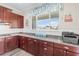 Charming kitchen with granite counters, modern cabinets, and a sunny window overlooking the yard at 9926 Sw 95Th Loop, Ocala, FL 34481