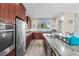 Well-appointed kitchen boasts granite countertops, stainless steel appliances, and ample cabinet space at 9926 Sw 95Th Loop, Ocala, FL 34481