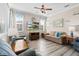 Spacious living room featuring a ceiling fan, hardwood floors and multiple seating options at 9926 Sw 95Th Loop, Ocala, FL 34481