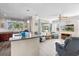 Open floor plan showcases kitchen island and cozy living area with a ceiling fan at 9926 Sw 95Th Loop, Ocala, FL 34481