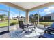 Inviting screened porch with stylish table and chairs perfect for outdoor dining and relaxation with beautiful views at 9926 Sw 95Th Loop, Ocala, FL 34481