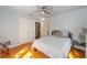 Cozy bedroom featuring a ceiling fan, wood floors, and neutral walls at 114 Ne 11Th Ave, Ocala, FL 34470